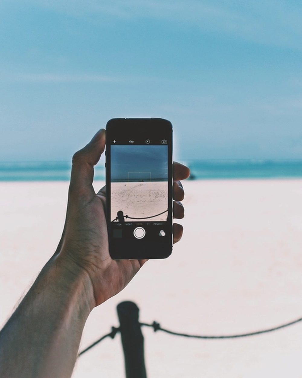 Checking the boat’s position on a phone at the pier
